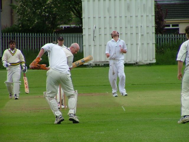 Spud \"I really know shinty is better than hockey\" McLauchlan takes one behind the stumps.