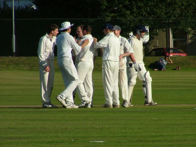 Andy Dodson and Ed argue over who gets credit for the wicket! Only Ed could ever look grumpy when a wicket\'s fallen!